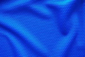 Blue football jersey clothing fabric texture sports wear background, close up top view photo