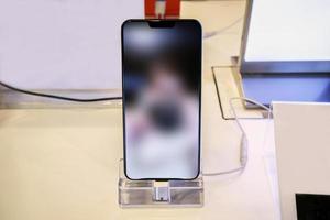 New mobile smartphone in telecommunication electronic store display showcase photo