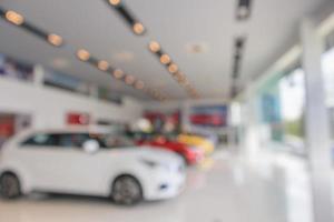 new cars in showroom blurred defocused background photo