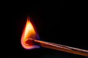 Smoke from burning matchsticks on a black background photo