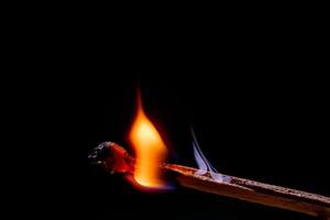 Smoke from burning matchsticks on a black background photo