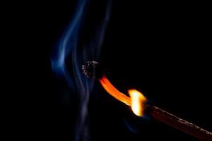 Smoke from burning matchsticks on a black background photo