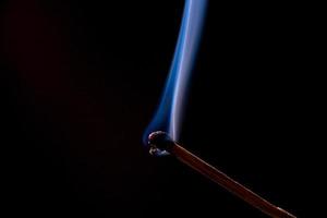 Smoke from burning matchsticks on a black background photo