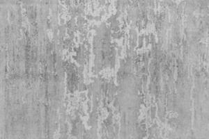 Gray concrete wall with with scratches and cracks. Textured background. photo