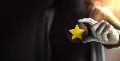 Success in Business or Personal Talent Concept. Young Employee Woman Holding a Golden Star photo