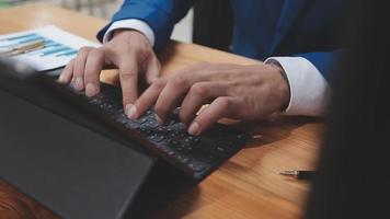 Businessman working with smart phone and laptop and digital tablet computer in office with digital marketing media in virtual icon video