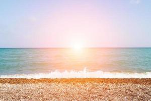 Sunset on a pebble beach. Horizontal image. photo