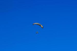 Flying with a para-glider in a clean day. Horizontal image. photo