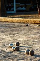 Game of petanque on the ground. Verical image. photo