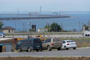 Taman, Russia-may 19, 2018 Landscape with a view of the Crimean bridge in the sea. photo