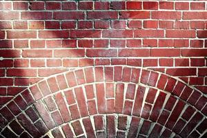 Aged and weathered brick wall textures with very bright spotlight illumination photo