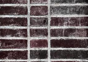 Detailed view at a colorful old and weathered brick wall texture as a panoramic background. photo