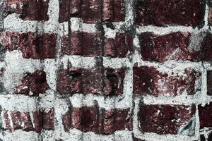 Detailed view at a colorful old and weathered brick wall texture as a panoramic background. photo