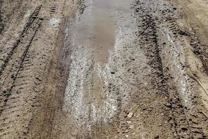 Close up on tire tracks on a muddy road. photo