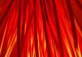 Motion blur defocused abstract Halloween background. Bundle of hay or straw or brushwood or sticks backlighted by red lamp like a fire. Dark red and orange vertical lines. photo