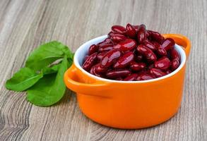 Red beans in a bowl on wooden background photo