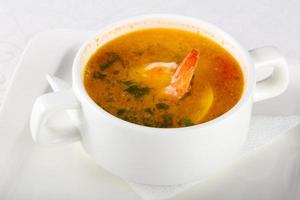 Prawn soup in a bowl on white background photo