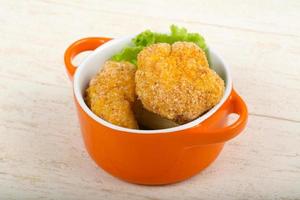 Crispy cauliflower in a bowl on wooden background photo