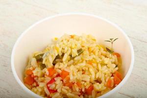 Mexican rice in a bowl on wooden background photo