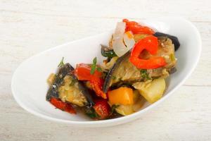 Steamed vegetables in a bowl on wooden background photo