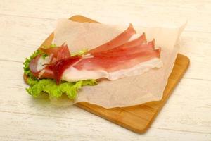 Hamon on wooden board and wooden background photo