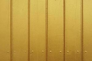 paneles de madera de pintura dorada o fondo de revestimiento de madera foto