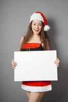 miss santa presenting blank sign with copy space photo