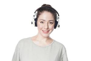 happy young woman listening to music with cordless over-ear headphones photo