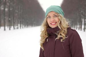 woman enjoying walk along snow covered alley photo