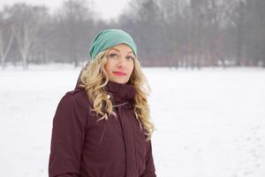 woman in snow covered park in winter photo