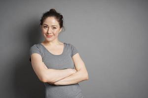 young woman with contented smile and crossed arms photo