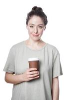 cheerful young woman holding coffee to go in disposable cup photo