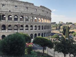 Italy, Rome, Colosseum. In the photo in the background is an ancient coliseum, in the foreground are trees