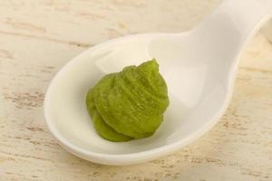 Wasabi in a bowl on wooden background photo