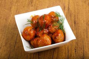 Meat balls in a bowl on wooden background photo