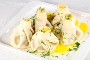 Khinkali on the plate and white background photo