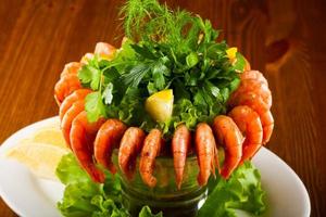 Prawn cocktail on the plate and wooden background photo