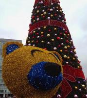 Christmas decorations in the form of a yellow bear and a Christmas tree. photo