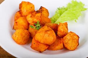 Baked potato on the plate and wooden background photo