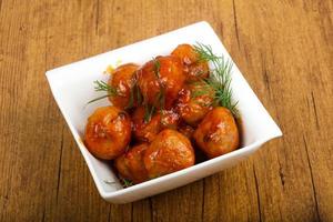 Meat balls in a bowl on wooden background photo