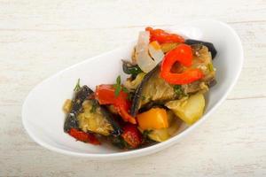 Steamed vegetables in a bowl on wooden background photo