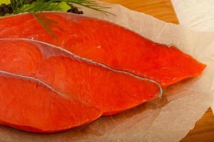 Salted salmon on wooden board and wooden background photo