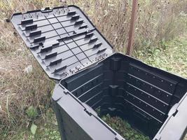 Plastic tank for the production and storage of compost in the garden photo