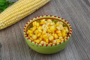 Sweet corn in a bowl on wooden background photo