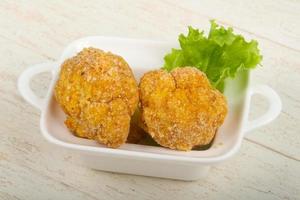 Crispy cauliflower in a bowl on wooden background photo