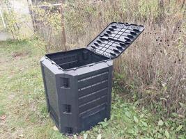 Plastic tank for the production and storage of compost in the garden photo