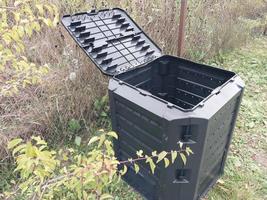 Plastic tank for the production and storage of compost in the garden photo