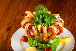 Shrimp cocktail on the plate and wooden background photo