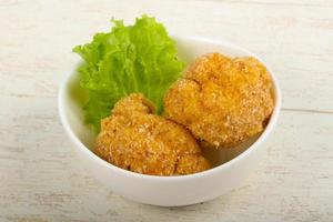 Crispy cauliflower in a bowl on wooden background photo