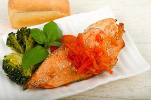 Baked Salmon on the plate and wooden background photo